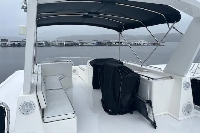 Slide: The Image of Upper deck of a 2008 Fantasy houseboat with seating and covered equipment. - 36