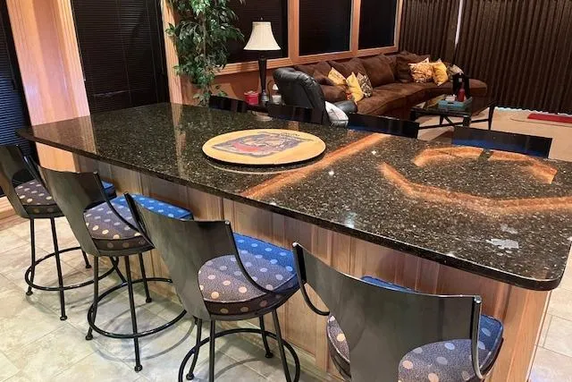 Slide: The Image of Luxurious houseboat interior with granite countertop, bar stools, and cozy seating area, 2008 Fantasy model. - 9