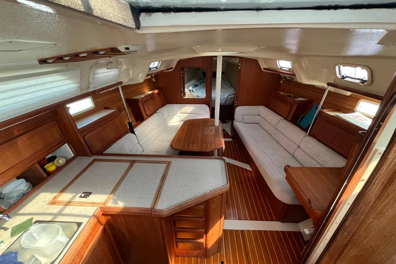 Slide: The Image of Interior of 1995 Hunter Legend 37.5 sailboat with wood finish and cozy seating area. - 10