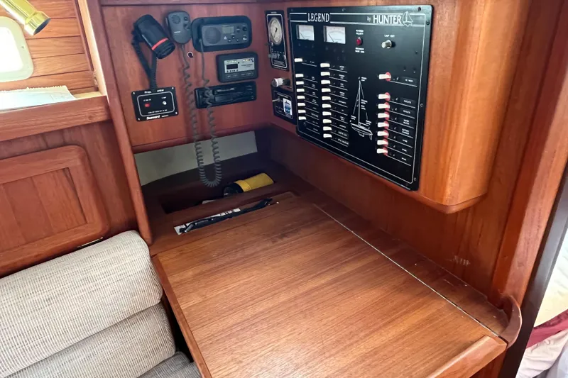 Slide: The Image of Interior of 1995 Hunter Legend 37.5 sailboat with control panel and wooden desk. - 15