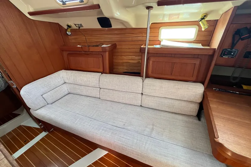 Slide: The Image of Interior of 1995 Hunter Legend 37.5 sailboat with wooden paneling and cushioned seating. - 18
