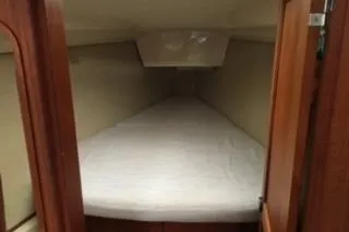 Slide: The Image of 1995 Hunter Legend 37.5 sailboat interior cabin with cozy bed and wooden finish. - 27