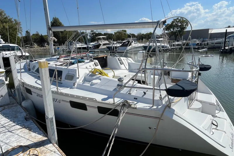 Slide: The Image of 1995 Hunter Legend 37.5 sailboat docked at a marina under clear skies. - 4