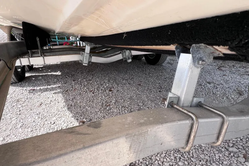 Slide: The Image of 2005 Parker 2510 Walkaround boat on trailer, showing undercarriage and support structure. - 13