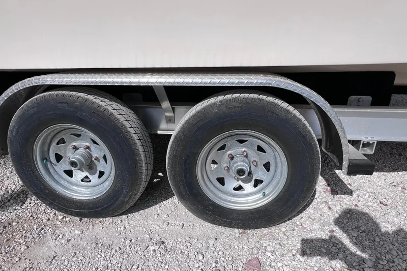 Slide: The Image of Trailer wheels of a 2005 Parker 2510 Walkaround boat on gravel surface. - 14