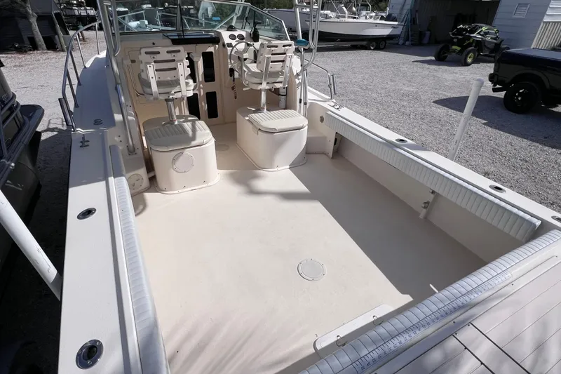 Slide: The Image of 2005 Parker 2510 Walkaround boat interior with seating and steering console. - 17
