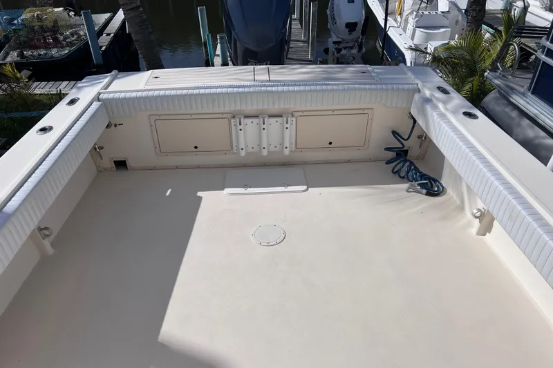 Slide: The Image of 2005 Parker 2510 Walkaround boat deck with storage compartments and coiled hose. - 18