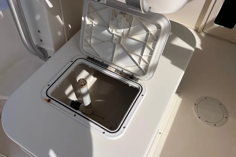 Slide: The Image of Open hatch on 2005 Parker 2510 Walkaround boat deck, revealing storage compartment. - 23