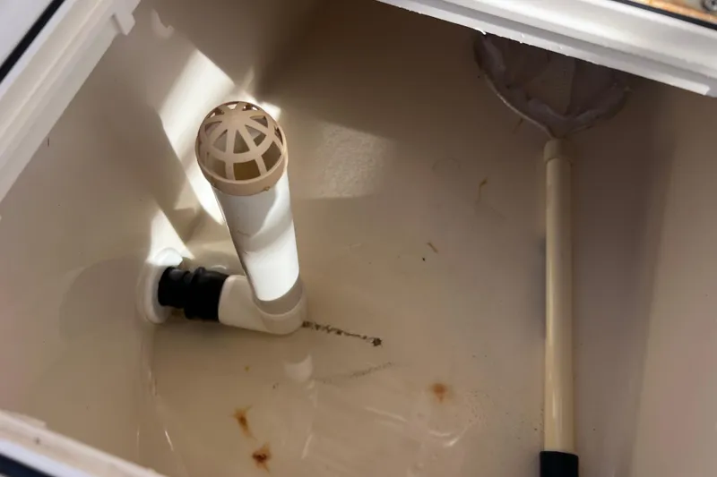 Slide: The Image of Livewell interior of 2005 Parker 2510 Walkaround boat, featuring drain and pipe. - 24