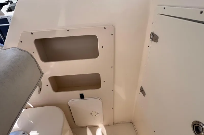 Slide: The Image of 2005 Parker 2510 Walkaround boat interior with storage compartments and seating. - 29