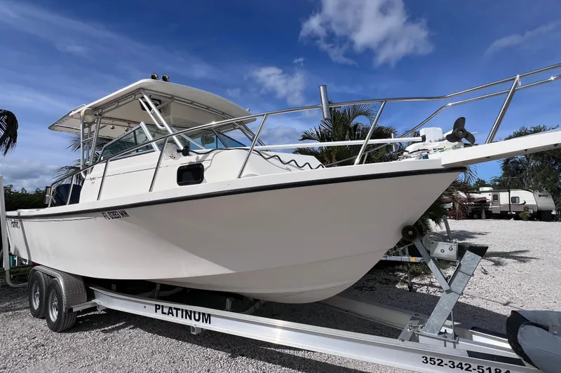 Slide: The Image of 2005 Parker 2510 Walkaround boat on trailer under blue sky. - 3