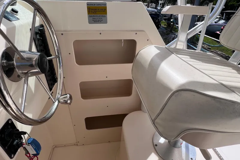 Slide: The Image of 2005 Parker 2510 Walkaround boat helm with steering wheel and cushioned seat. - 30