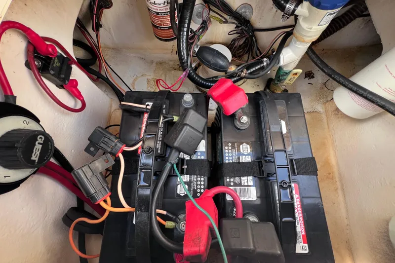 Slide: The Image of Battery compartment of a 2005 Parker 2510 Walkaround boat with wiring and connections. - 31