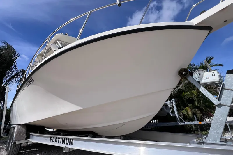 Slide: The Image of 2005 Parker 2510 Walkaround boat on trailer under clear blue sky. - 4