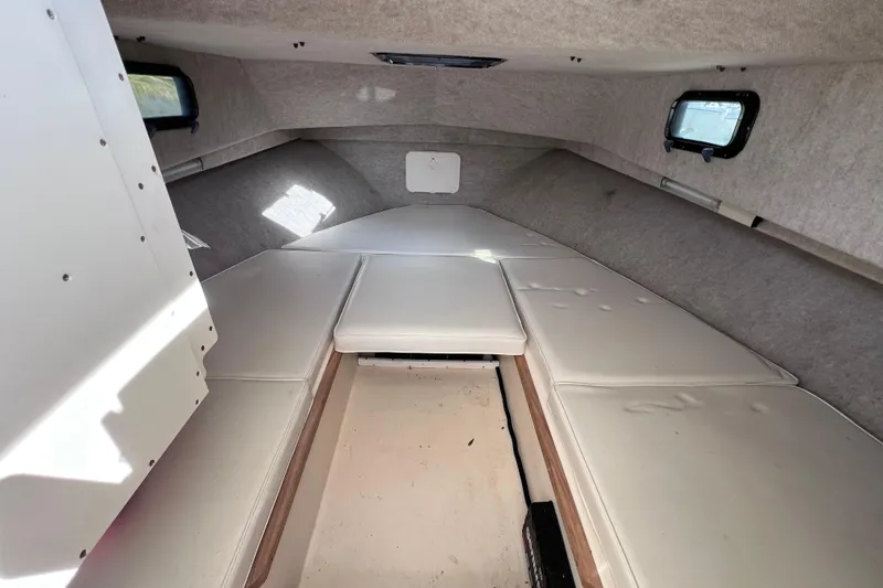 Slide: The Image of Interior cabin of 2005 Parker 2510 Walkaround boat with cushioned seating. - 47