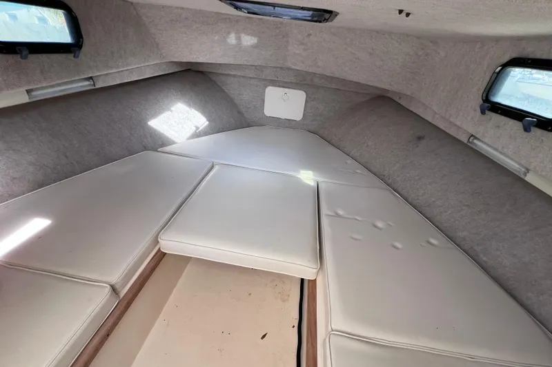 Slide: The Image of 2005 Parker 2510 Walkaround cabin interior with cushioned seating and windows. - 48