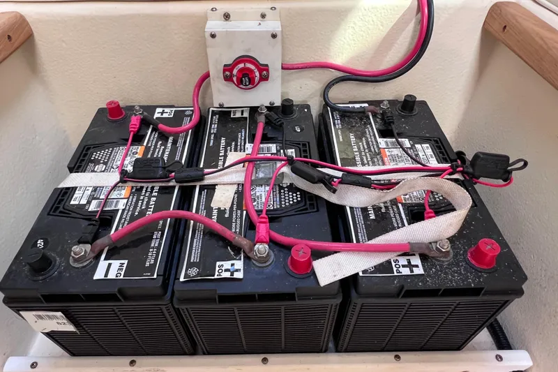 Slide: The Image of Battery setup in a 2005 Parker 2510 Walkaround boat, featuring three connected batteries. - 50