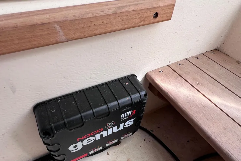 Slide: The Image of NOCO Genius GEN3 charger on 2005 Parker 2510 Walkaround boat with wooden trim. - 51