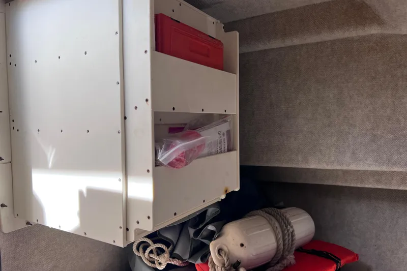 Slide: The Image of Interior storage of 2005 Parker 2510 Walkaround boat with safety equipment. - 52