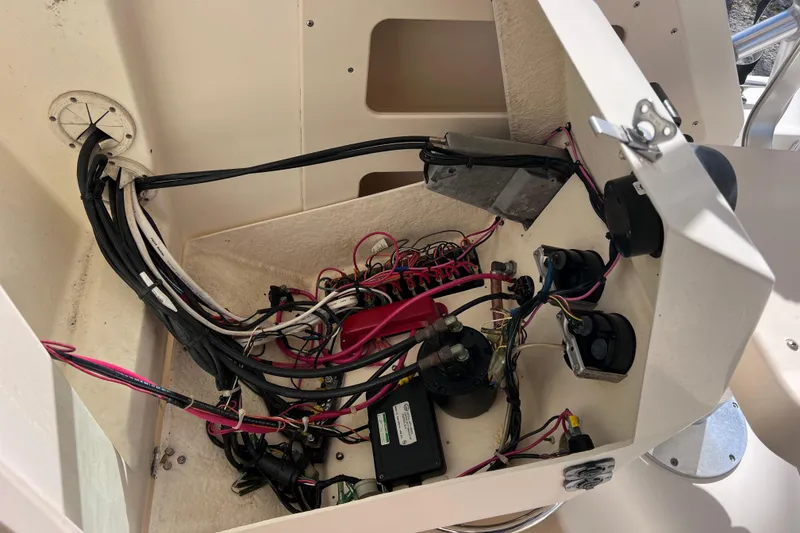 Slide: The Image of Electrical wiring inside a 2005 Parker 2510 Walkaround boat, showcasing cables and components. - 53