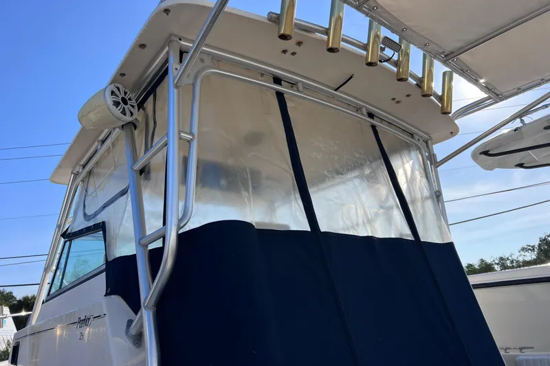 Slide: The Image of 2005 Parker 2510 Walkaround boat with blue canopy and rod holders, viewed from below. - 55