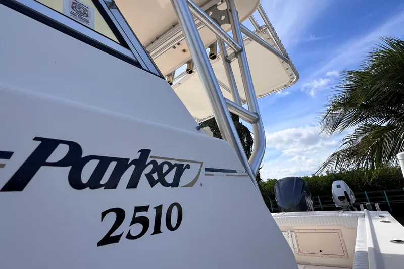 Slide: The Image of 2005 Parker 2510 Walkaround boat with palm trees and blue sky background. - 7