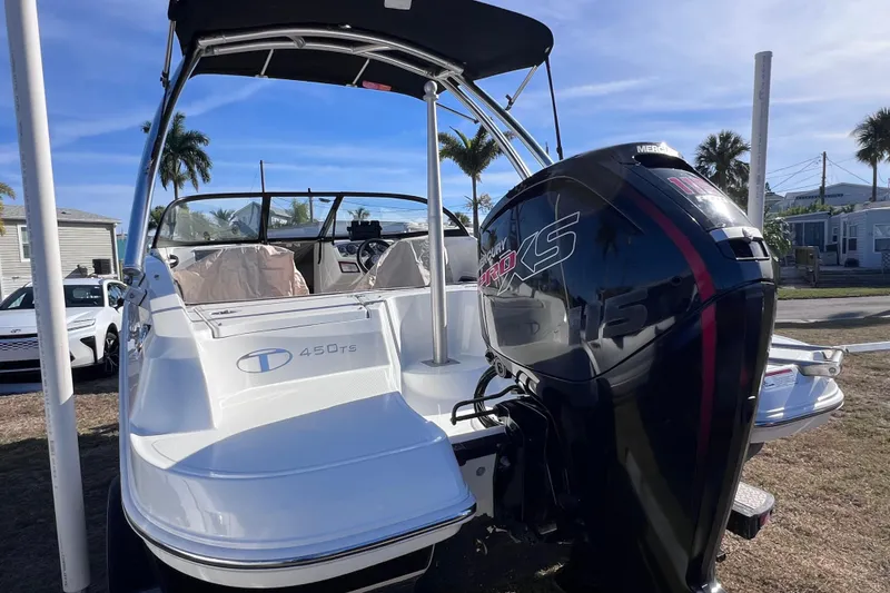 Slide: The Image of 2019 Tahoe 450 TS boat with Mercury Pro XS engine, parked outdoors. - 10
