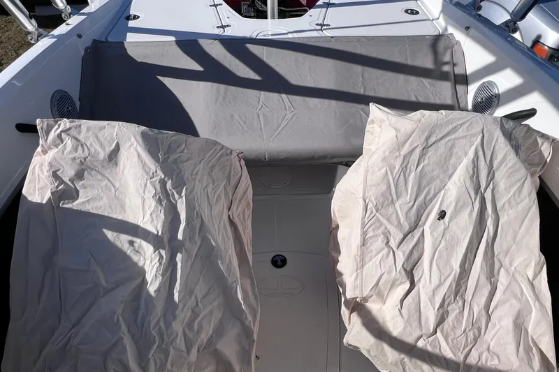 Slide: The Image of 2019 Tahoe 450 TS boat interior with covered seats and gray fabric shade. - 14