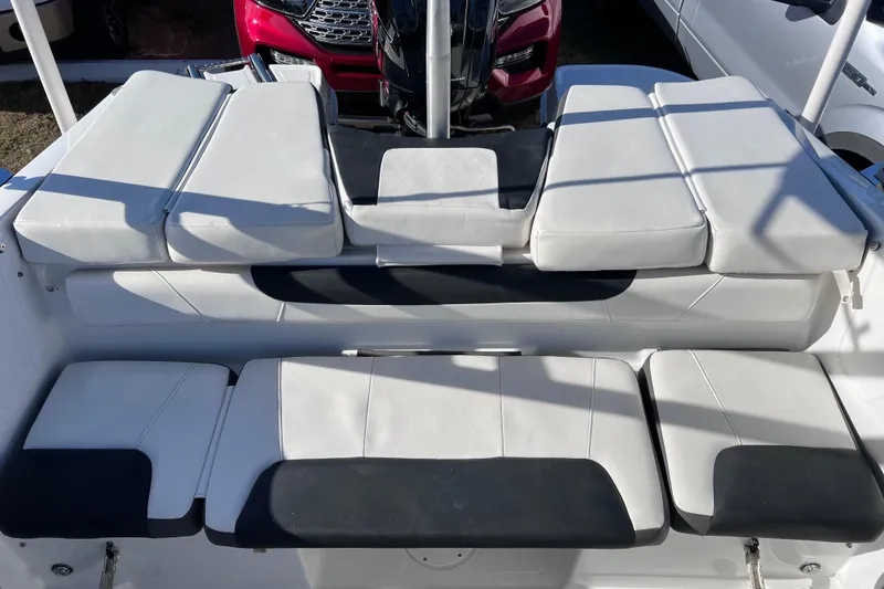 Slide: The Image of 2019 Tahoe 450 TS boat seating with white and black cushioned design. - 16