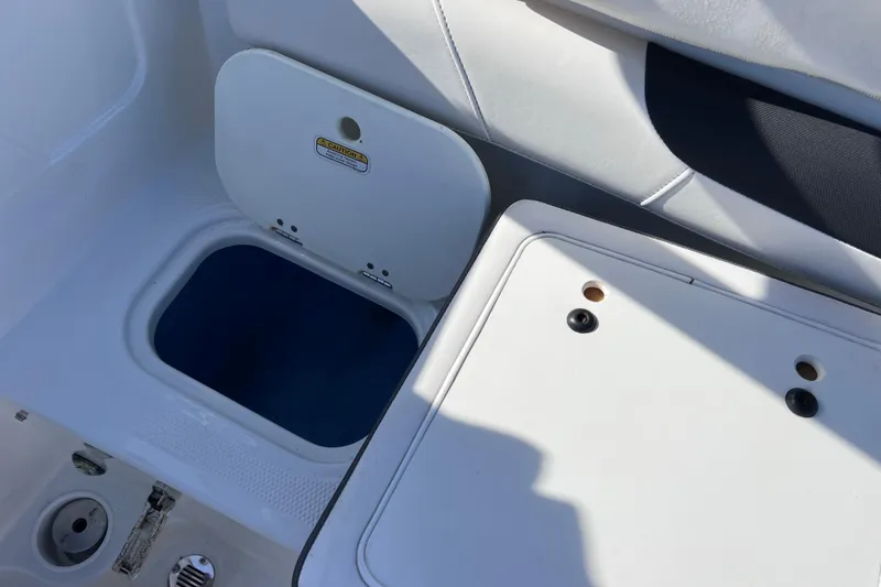 Slide: The Image of 2019 Tahoe 450 TS boat interior with storage compartment and seating area. - 17