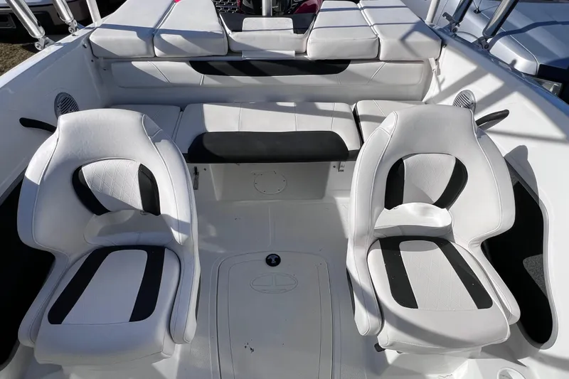 Slide: The Image of Interior of a 2019 Tahoe 450 TS boat with white and black seating. - 22
