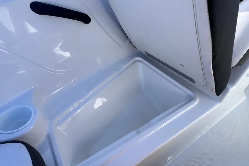 Slide: The Image of 2019 Tahoe 450 TS boat interior with storage compartment and cup holder. - 26