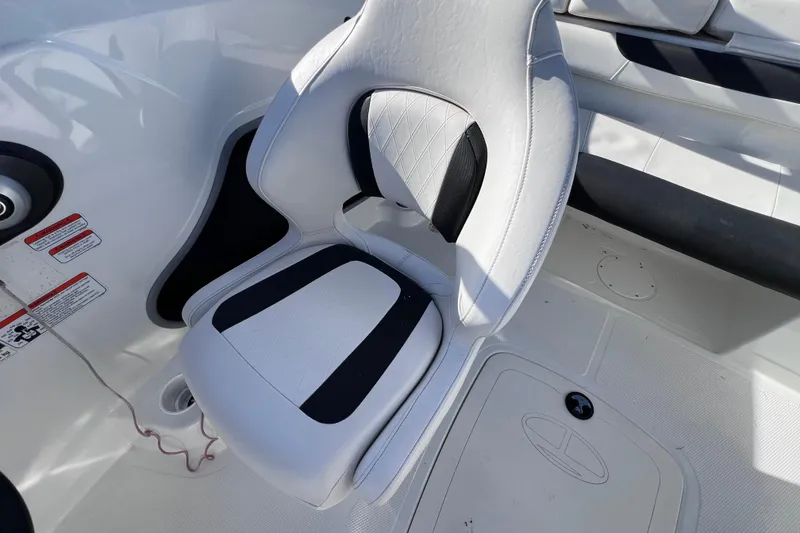Slide: The Image of White and black seat on 2019 Tahoe 450 TS boat interior. - 31