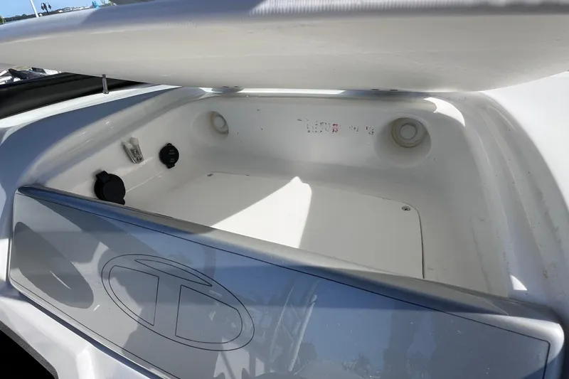 Slide: The Image of Open storage compartment in 2019 Tahoe 450 TS boat, featuring utility ports and sleek design. - 34