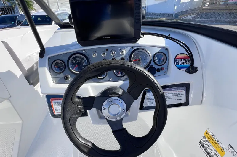 Slide: The Image of 2019 Tahoe 450 TS boat dashboard with steering wheel and Garmin display. - 35