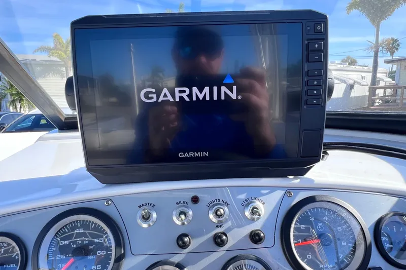 Slide: The Image of Garmin display on 2019 Tahoe 450 TS boat dashboard with gauges and controls. - 36