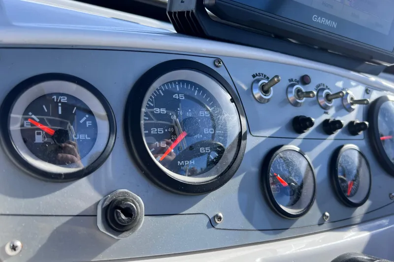 Slide: The Image of Dashboard of a 2019 Tahoe 450 TS boat with gauges and switches. - 42