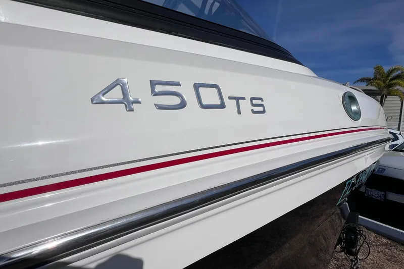 Slide: The Image of 2019 Tahoe 450 TS boat with sleek design and red accent stripe. - 8