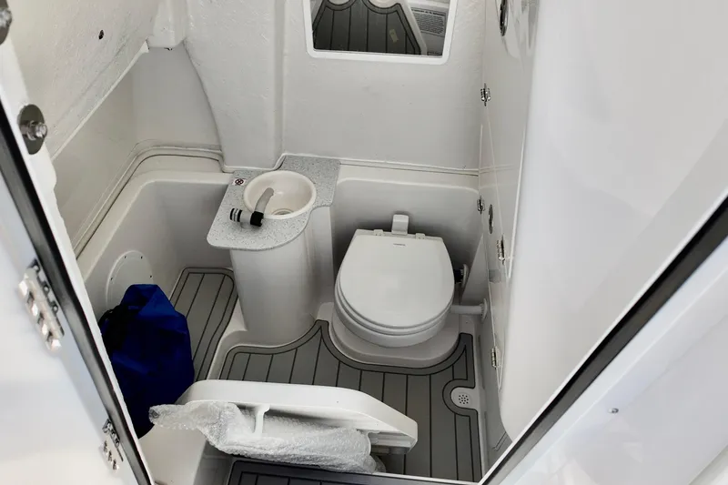 Slide: The Image of 2026 Sea Fox 268 Commander boat bathroom with toilet and sink, featuring modern design. - 10