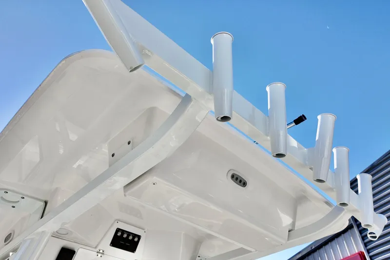 Slide: The Image of 2026 Sea Fox 268 Commander boat roof with rod holders against clear blue sky. - 12