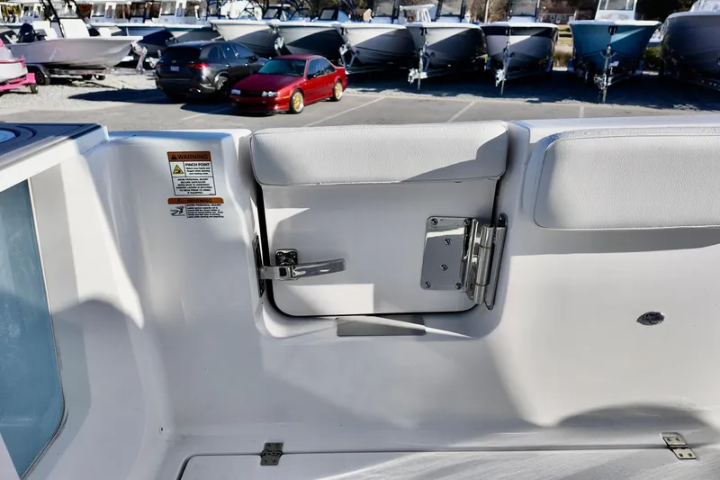Slide: The Image of 2026 Sea Fox 268 Commander boat interior with storage compartment and warning label. - 14