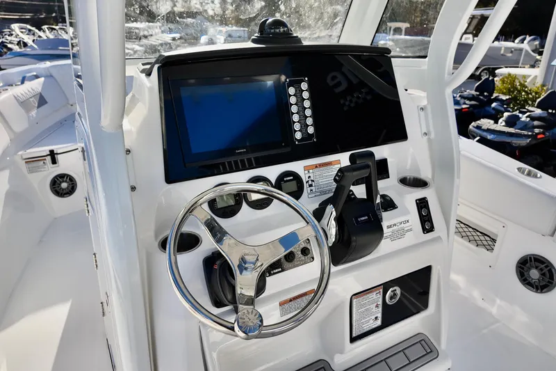 Slide: The Image of 2026 Sea Fox 268 Commander boat dashboard with steering wheel and navigation controls. - 18