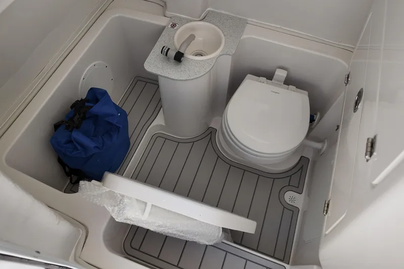 Slide: The Image of 2026 Sea Fox 268 Commander boat bathroom with toilet, sink, and storage bag. - 9