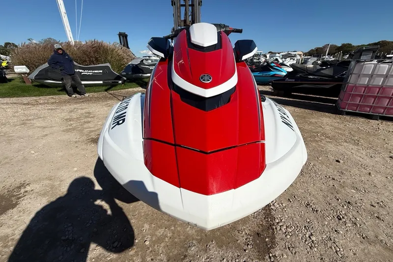 Slide: The Image of 2021 Yamaha WaveRunner FX Cruiser HO in red and white, parked outdoors. - 2