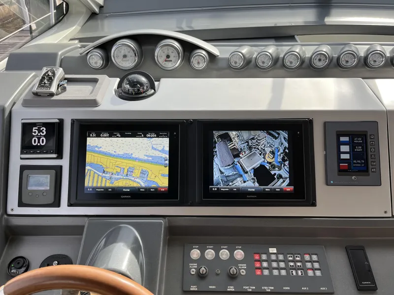 Slide: The Image of Control panel of a 2008 Azimut 62S yacht with navigation screens and gauges. - 16