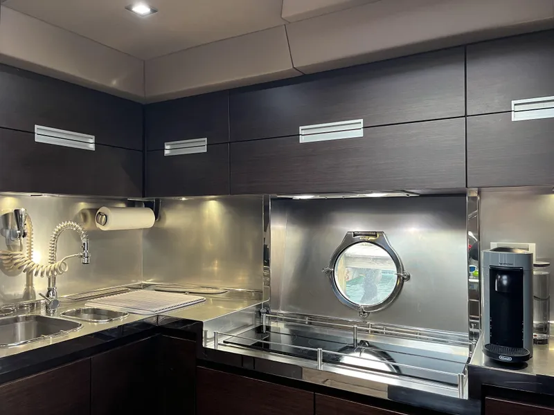 Slide: The Image of Luxurious kitchen interior of 2008 Azimut 62S yacht with modern appliances and sleek cabinetry. - 24