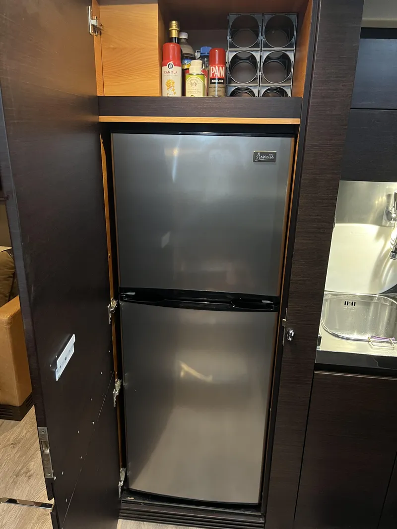 Slide: The Image of Built-in fridge in 2008 Azimut 62S yacht kitchen with storage above. - 25