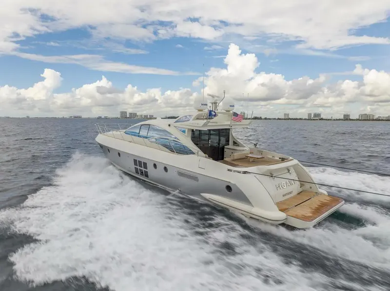 Slide: The Image of 2008 Azimut 62S yacht cruising on open water under a partly cloudy sky. - 3