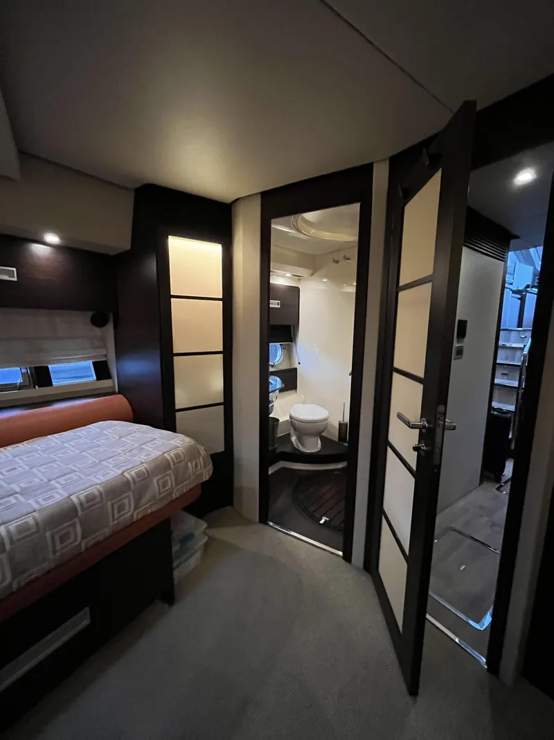 Slide: The Image of Interior of a 2008 Azimut 62S yacht featuring a bedroom and bathroom. - 32