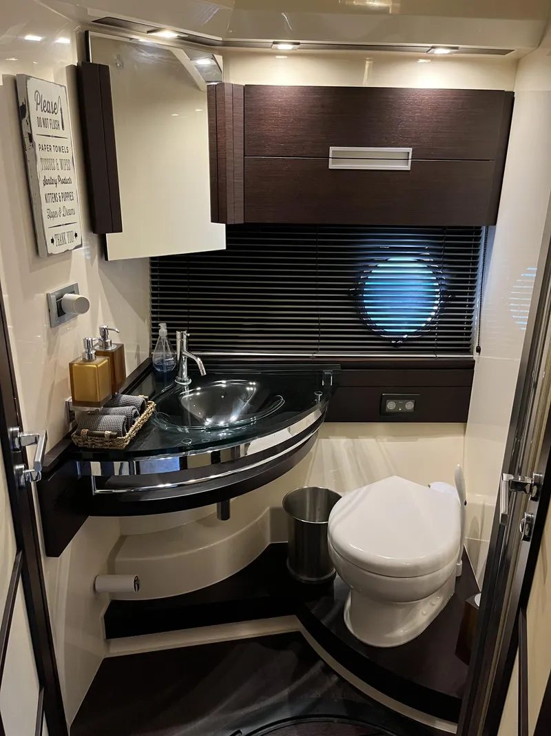 Slide: The Image of Luxurious bathroom in a 2008 Azimut 62S yacht with modern fixtures and porthole. - 33